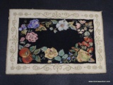 FLORAL AREA RUG; RESEMBLES A BERBER STYLE RUG AND HAS A FLORAL AND FRUIT PATTERN MADE INTO IT.