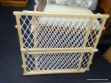 BABY GATE; IS ADJUSTABLE. GREAT FOR KEEPING THE LITTLE ONE(S) FROM GETTING OUT AND ABOUT WHILE