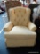 SUNNY YELLOW UPHOLSTERED SWIVEL ROCKING CHAIR; ROUNDED BACK, BUTTON TUFTED WITH PLEATED ARMS, PIPED