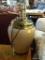 URN SHAPED LAMP BASE; LIGHT RUST IN COLOR WITH GOLD TONED TOP AND BOTTOM TRIM. MEASURES 12 IN