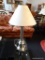 BRUSHED SILVER COLORED TABLE LAMP WITH BEIGE FAN SHAPED LAMPSHADE; COLUMN SHAPED LOWER POST MOUNTED