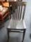 VINTAGE PLANK BOTTOM SIDE CHAIR; IS PAINTED BLACK AND HAS A SLAT STYLE BACK. MEASURES 17 IN X 19 IN