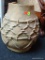 TRIBAL URN; HAS A ROPED PATTERN ON THE EXTERIOR. MAY HAVE BEEN USED AS A WATER JUG OR TO CARRY ITEMS