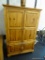 ENTERTAINMENT ARMOIRE; PINE WOOD GRAIN FINISH ENTERTAINMENT ARMOIRE MEDIA CENTER WITH TWO LARGE