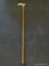 BRASS HANDLED WALKING CANE; WOODGRAIN WALKING CANE WITH BLACK RUBBER END CAP AND SCROLL DETAILED