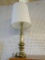 VINTAGE TURNED BRASS TABLE LAMP WITH WHITE LINEN-LOOK DRUM-SHAPED LAMPSHADE; FOOTED BASE, MEASURES