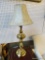 TALL BRASS BASE TABLE LAMP WITH TAN LEATHER-LOOK LAMPSHADE; PIERCED SEGMENT IN CENTER OF POST, SITS