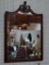 (WALL) ANTIQUE MAHOGANY FRAMED MIRROR WITH PLUME DETAILED CREST AND ROPED/TASSELED EDGES. MEASURES