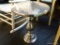 (BACK) SILVER COLORED ROUND TOP PEDESTAL TABLE; GLOSSY SILVER METAL TABLE WITH SINGLE TURNED