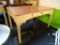 (BACK) SINGLE DRAWER TAN COLORED DESK/TABLE WITH WOOD GRAIN TOP SURFACE; SINGLE DRAWER PIECE CAN BE