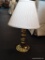 BRASS BASE DESK LAMP WITH PLEATED OFF-WHITE LAMPSHADE; MEASURES 18.5 IN TALL.