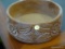 CARVED WOODEN BOWL; ROUND BOWL WITH FLOWER AND LEAF PATTERNED SIDES. MEASURES 9 3/4 IN DIAMETER X 4