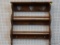 HANGING WOODEN WALL SHELF; STAINED WOOD FINISH, TOP LEDGE OVER TRIPLE HEART CUTOUT BACK RAIL, WITH 2