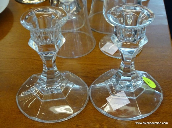 SET OF GLASS CANDLESTICK HOLDERS; SET OF TWO CLEAR GLASS CANDLESTICK HOLDERS . MEASURES 4 IN TALL.