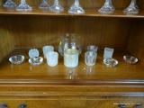 GLASS CANDLE/VOTIVE HOLDERS SHELF LOT; 13 TOTAL PIECES. ITEMS FROM BOTTOM SHELF INSIDE CABINET