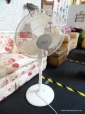 FEATURE COMFORTS OSCILLATING PEDESTAL FAN; WHITE IN COLOR, ROUND, ON AN ADJUSTABLE PEDESTAL BASE,
