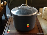 LIDDED CALPHALON STOCK POT; GREY IN COLOR WITH GLASS LID, 8 QT CAPACITY, #808. MEASURES 10.5 IN
