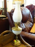 VINTAGE MILK GLASS TABLE LAMP; PATTERNED WHITE CHIMNEY WITH URN SHAPED PEDESTAL ON A ROUND BRASS