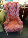 RED CHEVRON TALL WING CHAIR; VIBRANT CLARET RED WITH A WATERCOLOR CHEVRON PATTERN IN TAN AND BLUE.