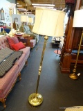 BRASS REEDED FLOOR LAMP WITH BEIGE-GOLD COLORED DRUM LAMPSHADE; HAS FINIAL AND HARP INCLUDED.