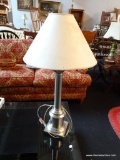 BRUSHED SILVER COLORED TABLE LAMP WITH BEIGE FAN SHAPED LAMPSHADE; COLUMN SHAPED LOWER POST MOUNTED