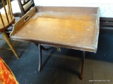 BUTLERS TABLE; BROWN PAINTED LIFT TRAY BUTLERS TABLE WITH X STYLE BASE. MEASURES 24 IN X 18 IN X 23