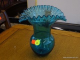 BLUE RUFFLED EDGE GLASS VASE; IS HAND BLOWN. MEASURES 8 IN X 8 IN