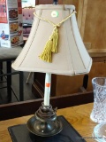 TABLE LAMP; CANDLESTICK STYLE TABLE LAMP WITH BRASS BASE. HAS SHADE AND FINIAL AND MEASURES 22 IN