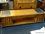CABINET STYLE COFFEE TABLE; LONG WOODEN COFFEE TABLE THAT HAS TWO BLACK HOT PLATES, ONE ON EACH