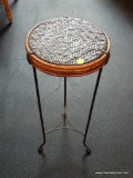 PLANT STAND; CAST IRON AND WICKER PLANT STAND. MEASURES 11 IN X 25 IN