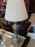SILVER COLORED LAMP; WITH PLEATED OATMEAL COLORED LAMP SHADE WITH GREY BANDED TRIM, LAMP BASE IS