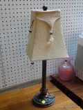 (BACK) BEADED TABLE LAMP; CREAM COLORED SQUARE LAMP SHADE WITH CHAMPAGNE COLORED FABRIC HANGING OVER