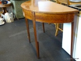DEMILUNE TABLE; MAHOGANY DEMILUNE TABLE WITH TAPERED LEGS. HAS BEEN REPAIRED BUT OTHERWISE IS IN