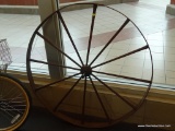 WAGON WHEEL; LARGE ANTIQUE WAGON WHEEL WITH CAST IRON CENTER AND WOODEN SPOKES. MEASURES 44.5 IN