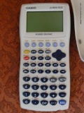 GRAPHING CALCULATOR; CASIO FX-9750G PLUS MODEL, LIGHT GREY AND TEAL GREEN IN COLOR. ESSENTIALS FOR