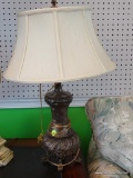 BRONZE COLORED TABLE LAMP WITH CREAM COLORED LAMPSHADE; HAS FINIAL, HARP, IVORY COLORED BELL SHAPED