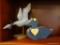 WOODEN DUCKS DECOR SHELF LOT; 2 TOTAL PIECES. ONE IS A PLUSH PADDED STRIPED DUCK SILHOUETTE IN A