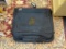 USMC BLACK CANVAS SUIT HANGING BAG; BLACK IN COLOR WITH A TAN/BROWN USMC EMBLEM ON THE FRONT OF THE