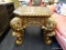 LARGE ORNATE GOLD AND BROWN CARVED END TABLE; OCTAGONAL TOP SURFACE WITH ROPED TRIM, INTRICATELY