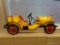 VINTAGE METAL CALL DECORATION; THIS WALL HANGING IS A YELLOW AND RED OLD TIMEY CAR MADE OUT OF