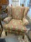 WINGBACK CHAIR; 1 OF A PAIR OF GREEN, GOLD AND RED TONED WINGBACK CHAIRS WITH MAHOGANY LEGS AND