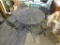 CAST IRON PATIO SET; CAST IRON AND MESHED WIRE PATIO TABLE SET WITH 4 CHAIRS. TABLE HAS A BUILT IN