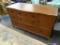 BUFFET; 5 DRAWER AND 1 DOOR BUFFET WITH BRASS BATWING PULLS AND REEDED FEET. IS IN EXCELLENT