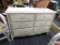 CREAM COLORED DRESSER; CREAM COLORED 6 DRAWER DRESSER WITH GOLD ACCENTS. RECTANGULAR BEVELED TOP