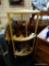 LIGHT WOODEN CORNER ETAGERE; 3 SHELVES WITH ROUND POSTS IN A LIGHT BLONDE WOOD FINISH. MEASURES 17.5