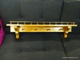 WOODEN HANGING WALL SHELF; WITH SPINDLED GALLERY RAIL, CARVED SUPPORT BRACES ON EITHER SIDE AND 4