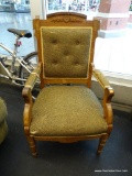EASTLAKE CARVED ARMCHAIR; INTRICATELY CARVED WALNUT FRAME WITH OLIVE GREEN/BLACK BURLAP UPHOLSTERY.
