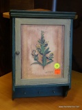 GREEN PAINTED HANGING CABINET; CROWN MOLDED TOP WITH LIGHTER GREEN BORDERED PANEL DOOR ON FRONT WITH