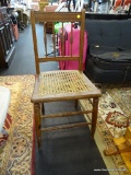 SPOOLED BACK WOODEN SIDE CHAIR WITH CANE SEAT; MEASURES 16 IN X 15 IN X 33 IN.