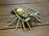 BRASS LOBSTER; HAS RED PAINTED EYES AND IS IN EXCELLENT CONDITION! MEASURES 5 IN LONG.